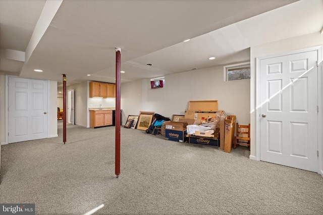 finished basement featuring recessed lighting and light colored carpet