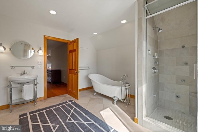 full bath with tile patterned flooring, vaulted ceiling, a freestanding bath, and a shower stall