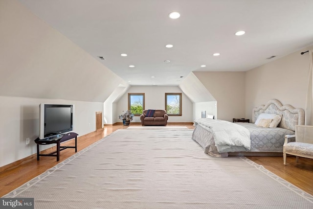 bedroom featuring visible vents, vaulted ceiling, wood finished floors, and recessed lighting