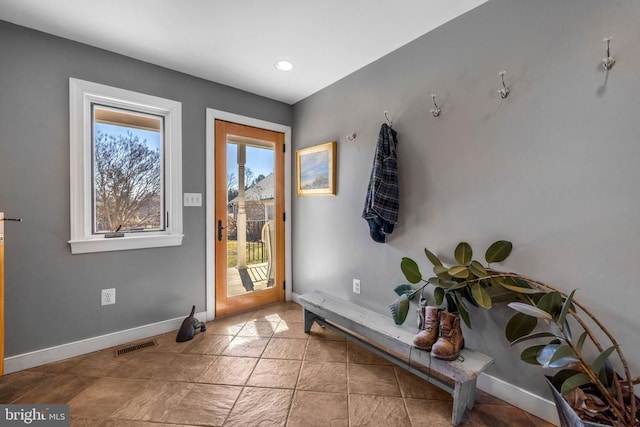 entryway with baseboards, visible vents, and recessed lighting