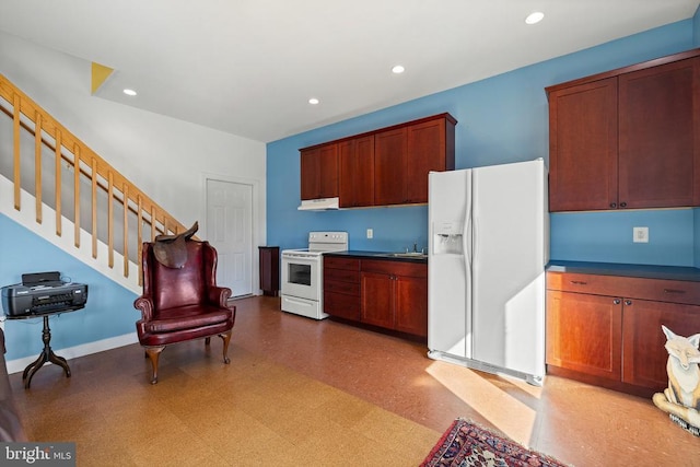 kitchen with white appliances, under cabinet range hood, light floors, and recessed lighting