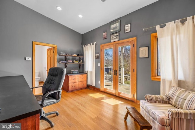 home office with recessed lighting, baseboards, vaulted ceiling, french doors, and light wood finished floors