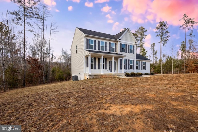 view of front of house with central air condition unit and covered porch