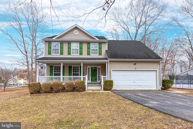 traditional-style home with driveway, a porch, a front lawn, and an attached garage