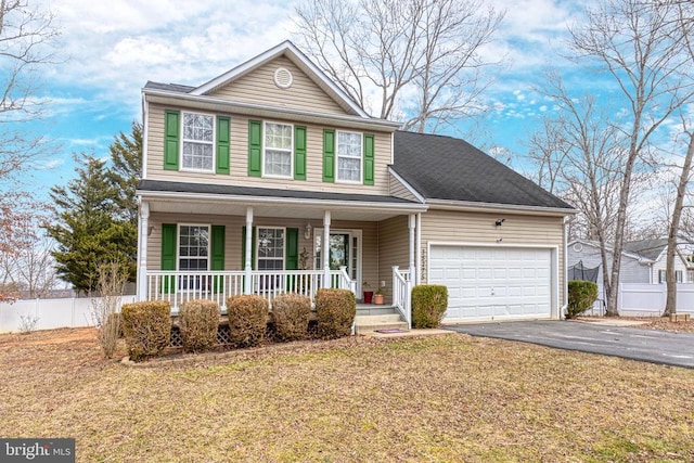 traditional-style home featuring a porch, a garage, fence, driveway, and a front yard