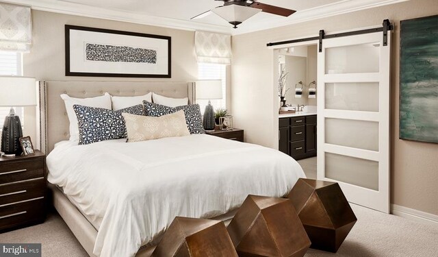 bedroom featuring crown molding, a barn door, and light colored carpet