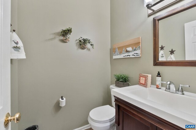 half bathroom with toilet and vanity