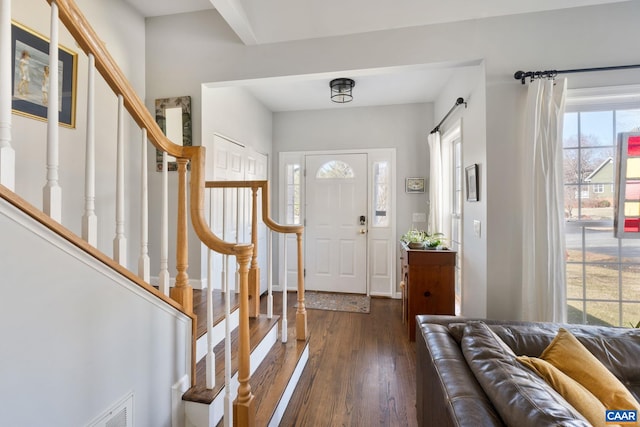 foyer featuring stairway and wood finished floors