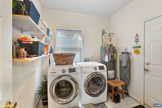 clothes washing area featuring water heater, laundry area, and washer and clothes dryer