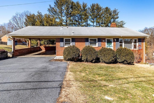 ranch-style home with a front lawn and a carport