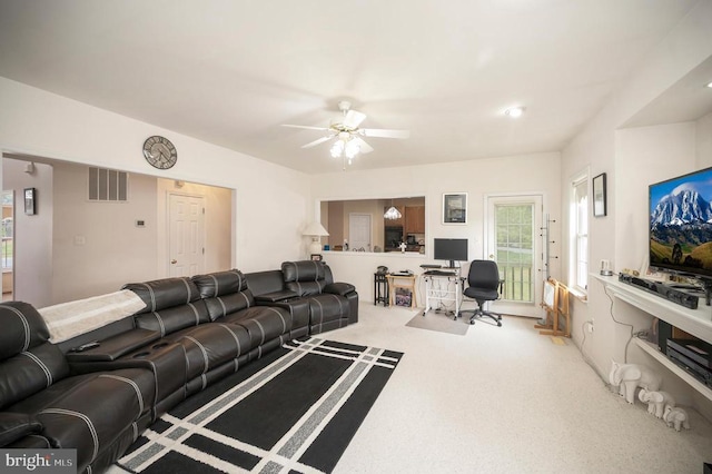 living room featuring ceiling fan and carpet flooring