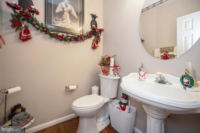 bathroom with wood-type flooring and toilet