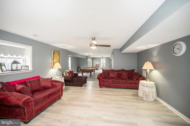 living room featuring ceiling fan and light hardwood / wood-style flooring