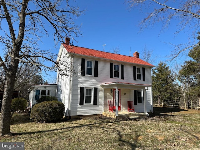 view of front of home with a front lawn and a chimney