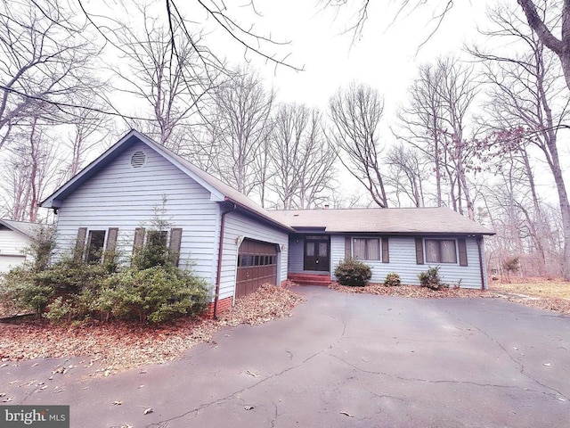 single story home featuring driveway and a garage