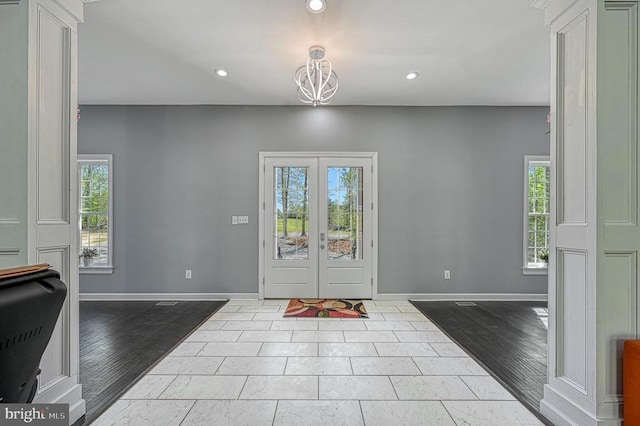 entrance foyer featuring wood finished floors, recessed lighting, baseboards, and french doors