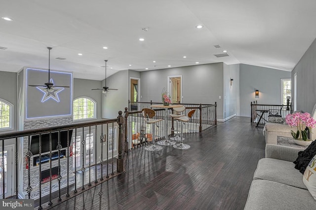 interior space featuring recessed lighting, baseboards, wood finished floors, and vaulted ceiling