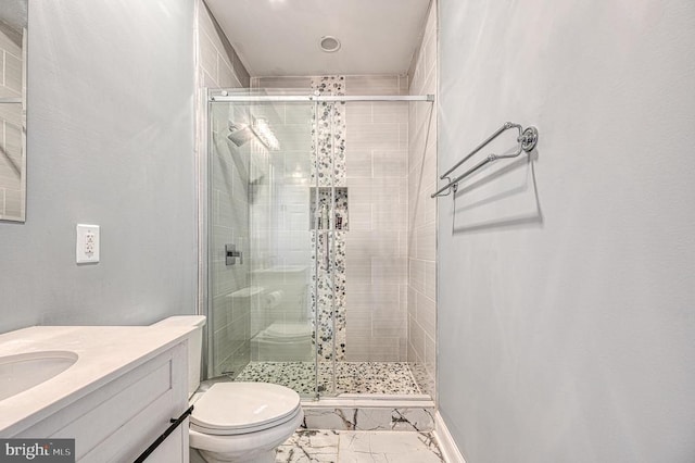 bathroom featuring vanity, toilet, marble finish floor, and a shower stall