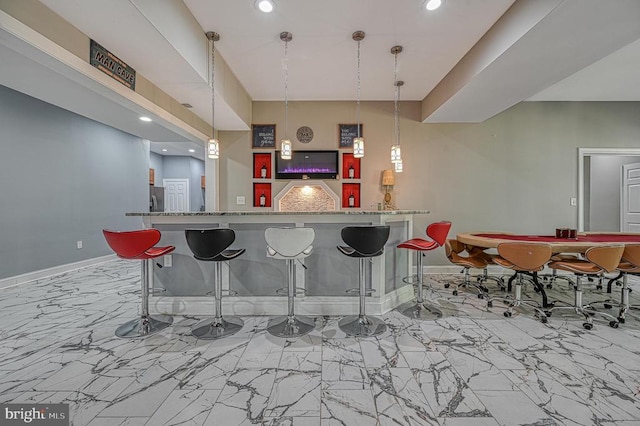 bar with a community bar, marble finish floor, and baseboards