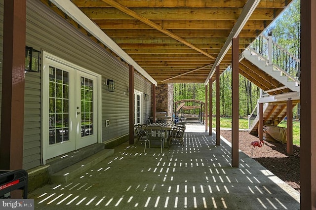 view of patio / terrace featuring french doors and stairs