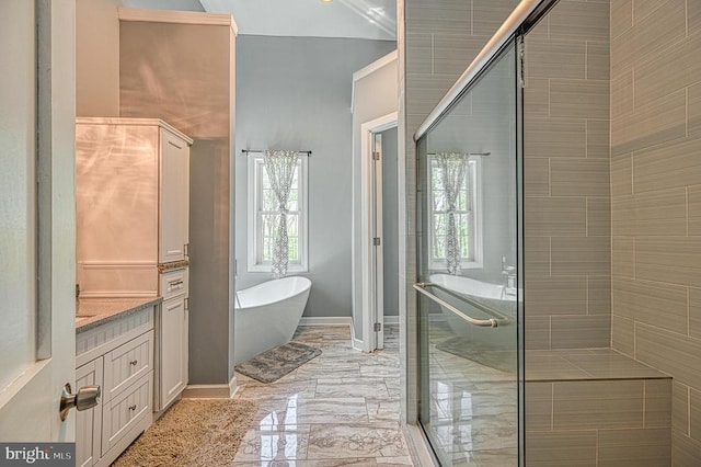 full bathroom with vanity, baseboards, a freestanding tub, a shower stall, and marble finish floor