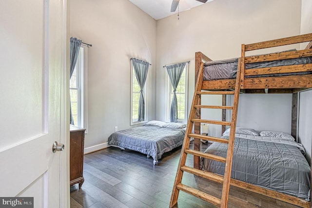 bedroom with wood finished floors, baseboards, and ceiling fan