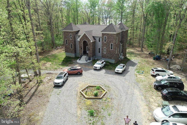 drone / aerial view featuring a forest view