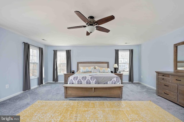 bedroom with light carpet, a ceiling fan, and baseboards