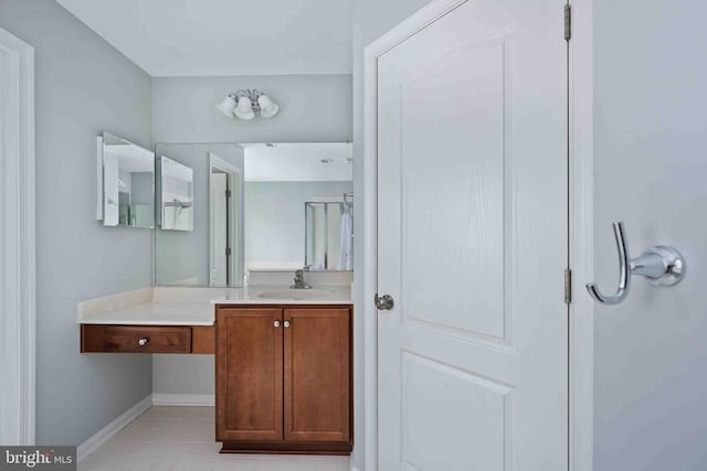 bathroom with tile patterned flooring, vanity, and baseboards