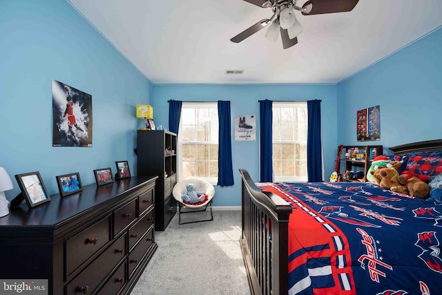 bedroom featuring light carpet, ceiling fan, and visible vents