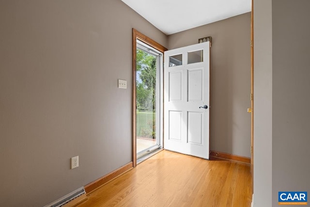 doorway to outside featuring light wood-style floors and baseboards
