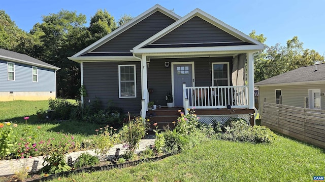 view of front of house featuring covered porch and a front lawn