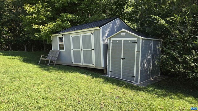 view of outbuilding featuring a yard