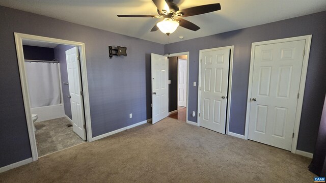 unfurnished bedroom featuring ceiling fan, ensuite bath, and light carpet