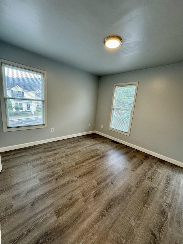 unfurnished room with dark hardwood / wood-style floors