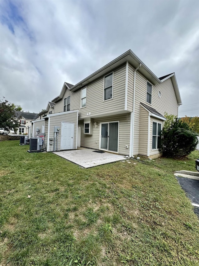 rear view of property with central AC, a lawn, and a patio