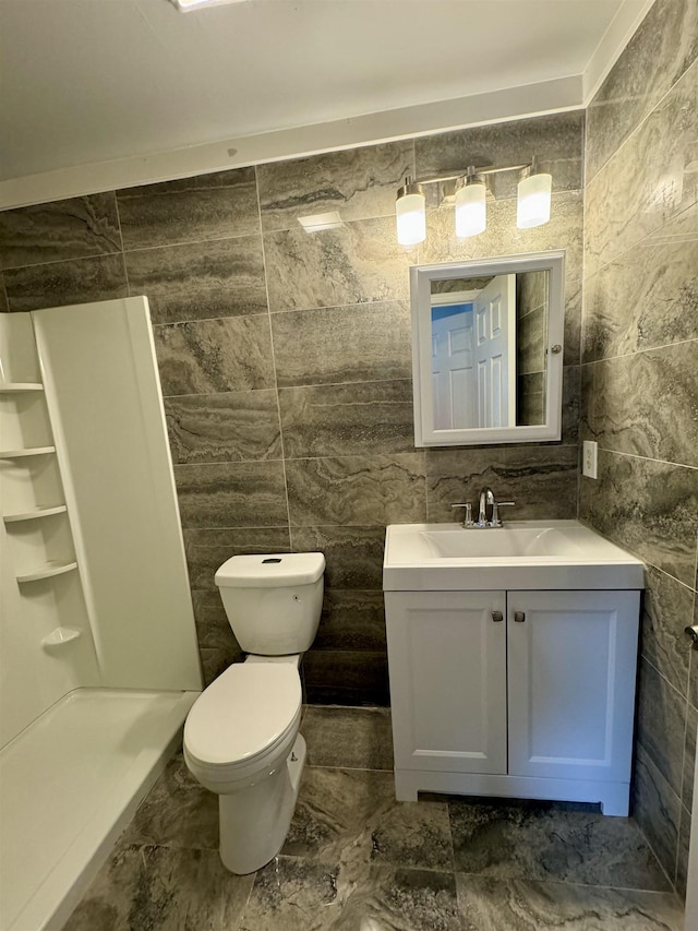 bathroom with vanity and tile walls