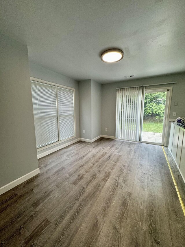 empty room with hardwood / wood-style flooring