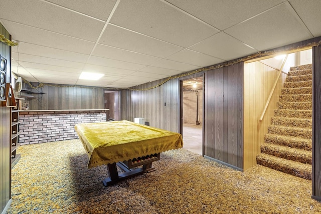 recreation room with carpet flooring, a paneled ceiling, wooden walls, and pool table