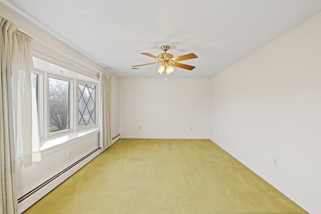 spare room with ceiling fan, carpet floors, and baseboard heating