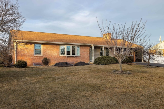 ranch-style home with a front lawn