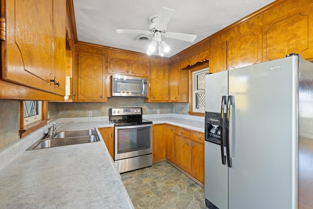 kitchen with ceiling fan, appliances with stainless steel finishes, and sink