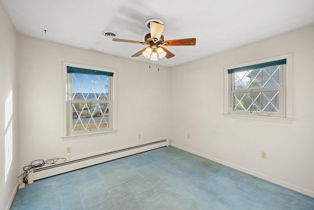 unfurnished room with a healthy amount of sunlight, a baseboard heating unit, ceiling fan, and carpet flooring