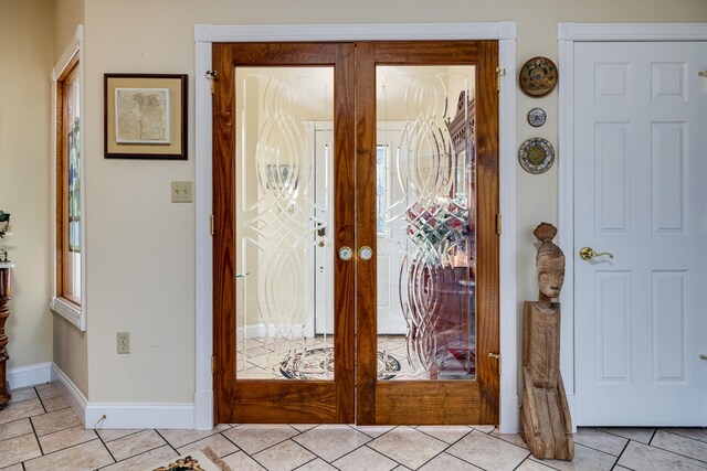 foyer entrance featuring light tile patterned floors and french doors