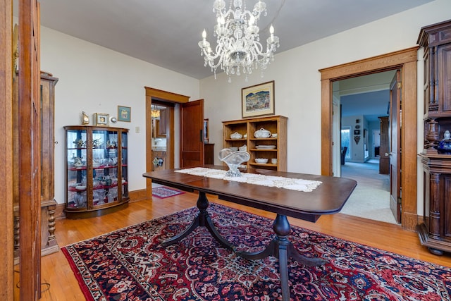 dining room featuring a chandelier and light wood-type flooring