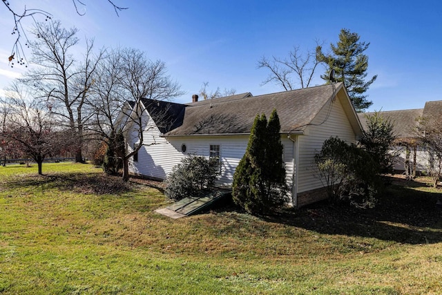 view of side of home with a lawn