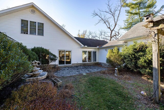 rear view of property featuring a patio area