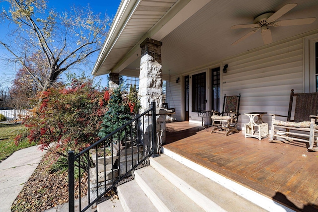 deck with ceiling fan and covered porch