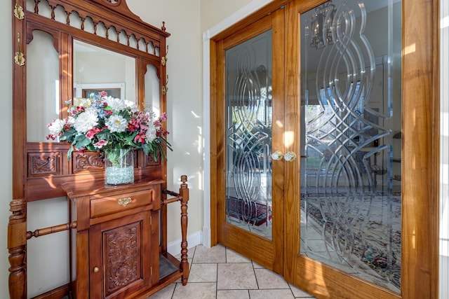 doorway with french doors and light tile patterned flooring