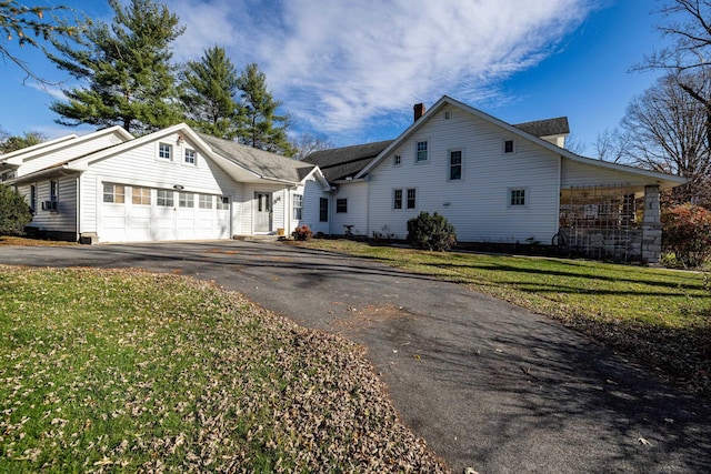 view of front facade with a garage and a front lawn